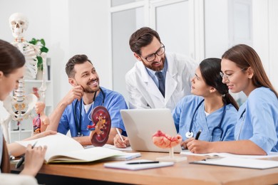 Photo of Doctor and interns near laptop in university