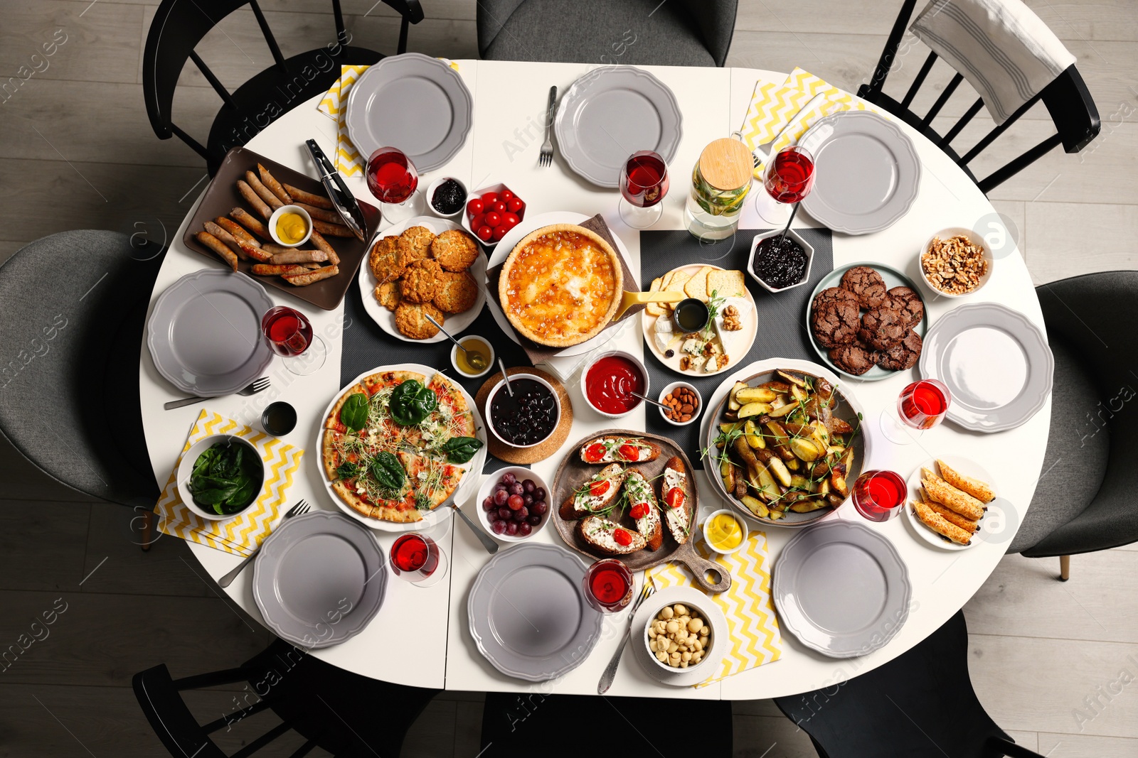 Photo of Brunch table setting with different delicious food and chairs indoors, top view