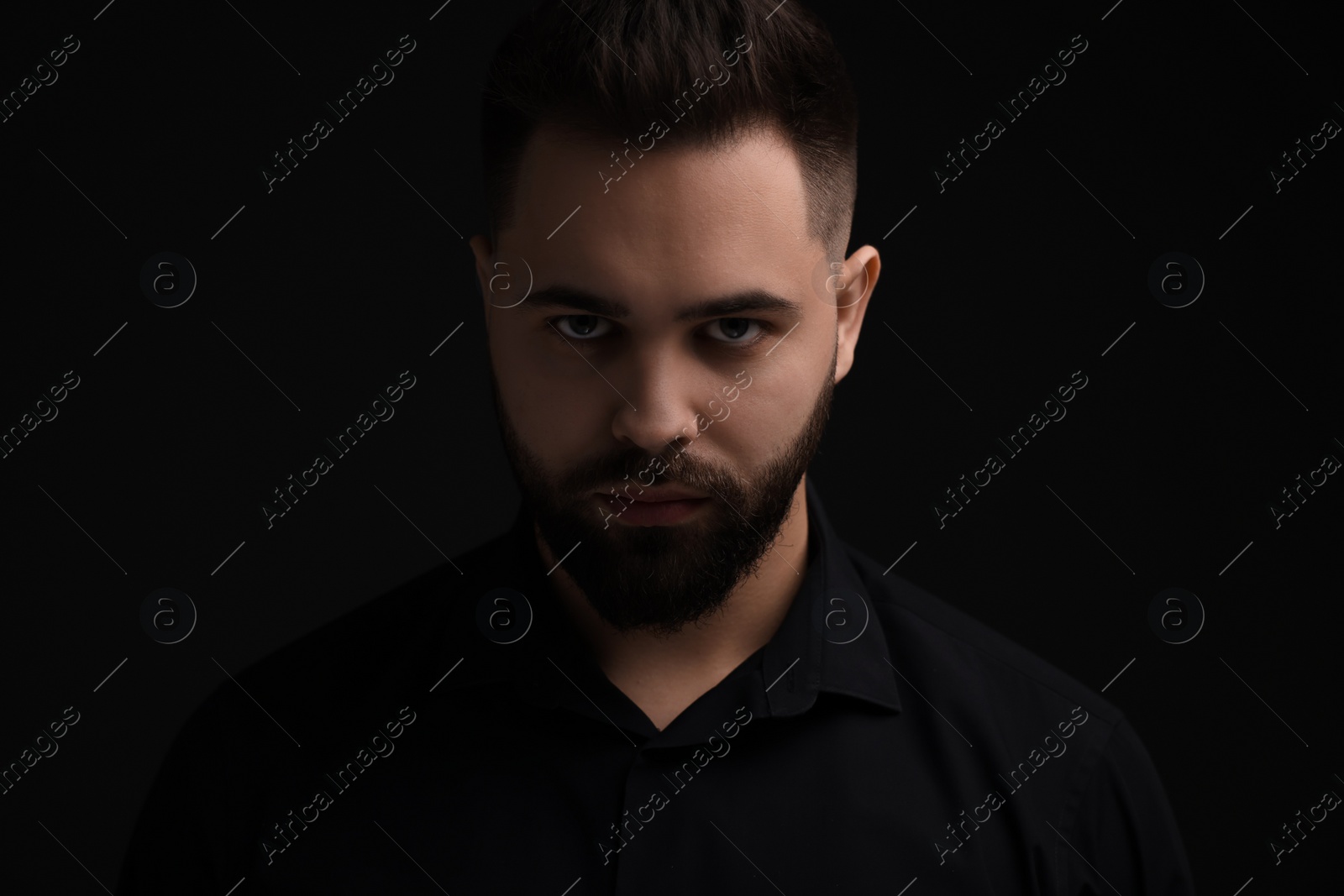 Photo of Evil eye. Man with scary eyes on black background