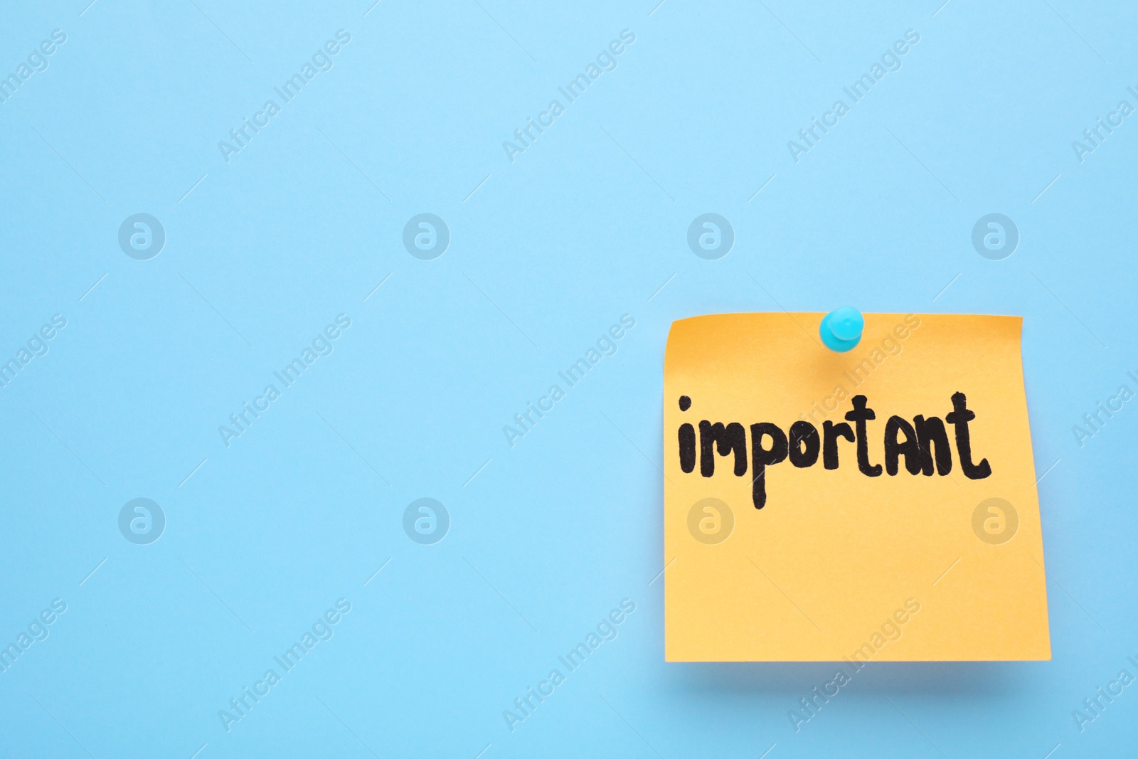Photo of Paper note with word Important pinned on light blue background, space for text