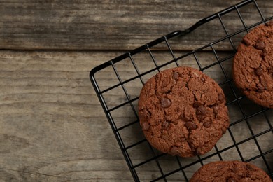 Delicious chocolate chip cookies on wooden table, top view. Space for text