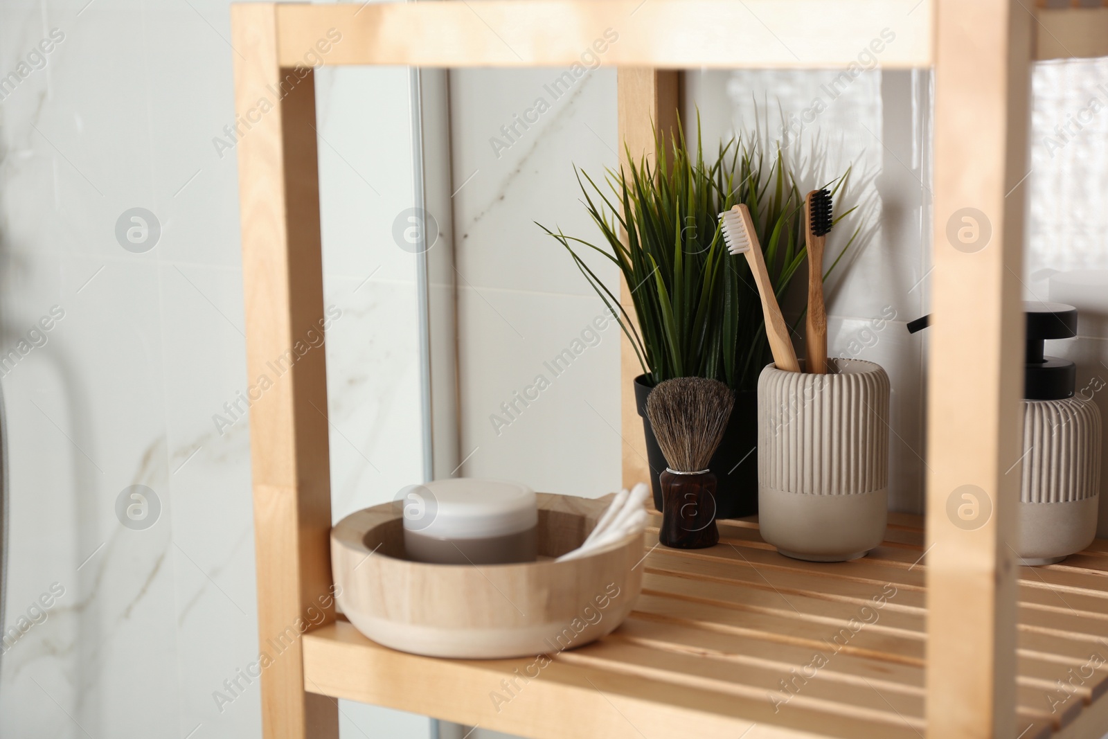 Photo of Shelving unit with toiletries in bathroom interior