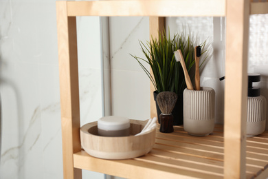 Shelving unit with toiletries in bathroom interior