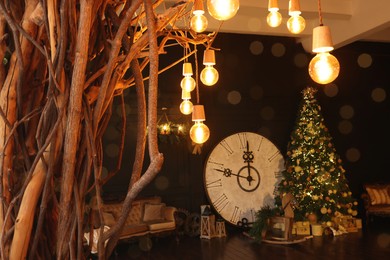 Stylish room interior with Christmas tree, big vintage clock and festive decor