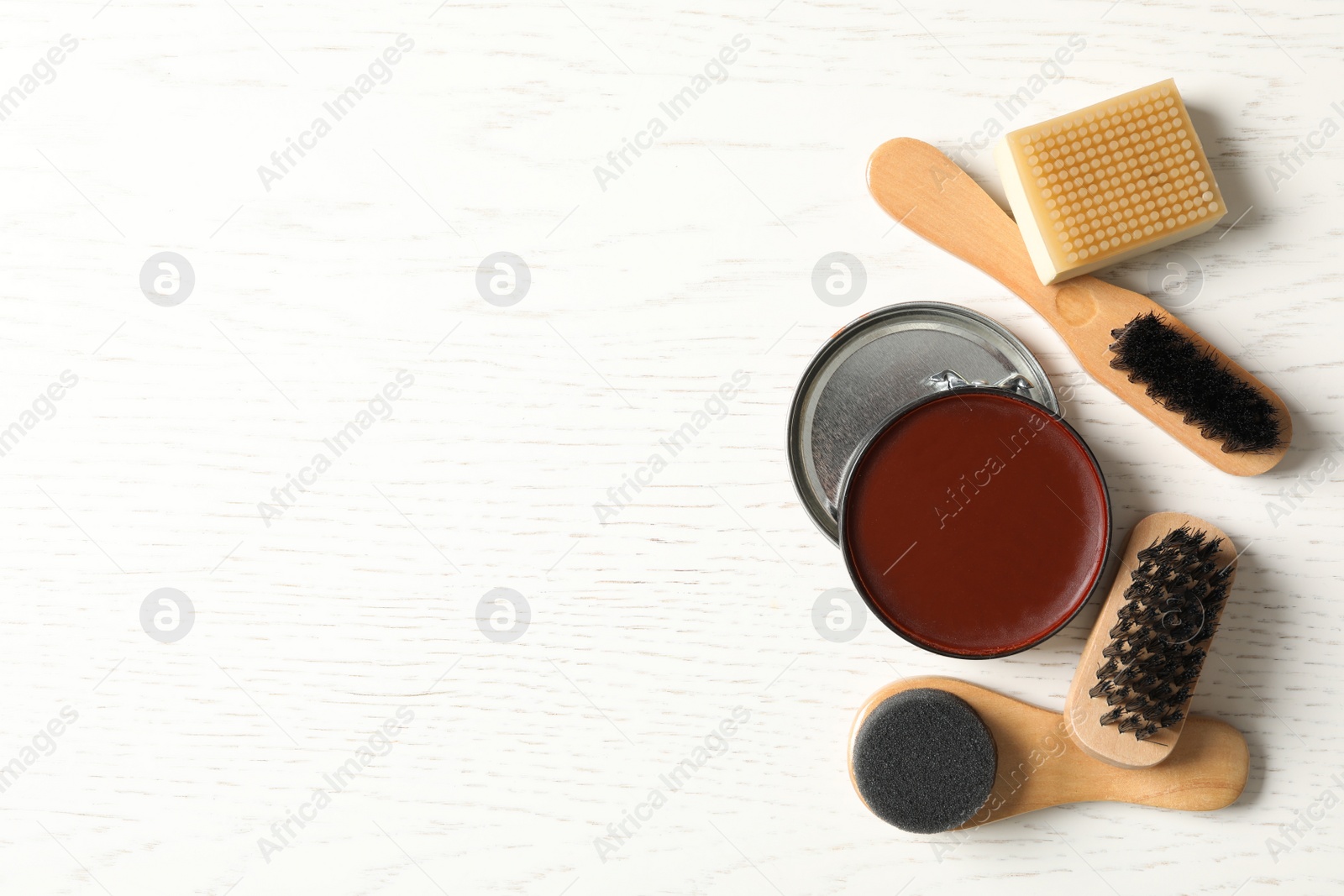 Photo of Flat lay composition with shoe care accessories on white wooden background, space for text