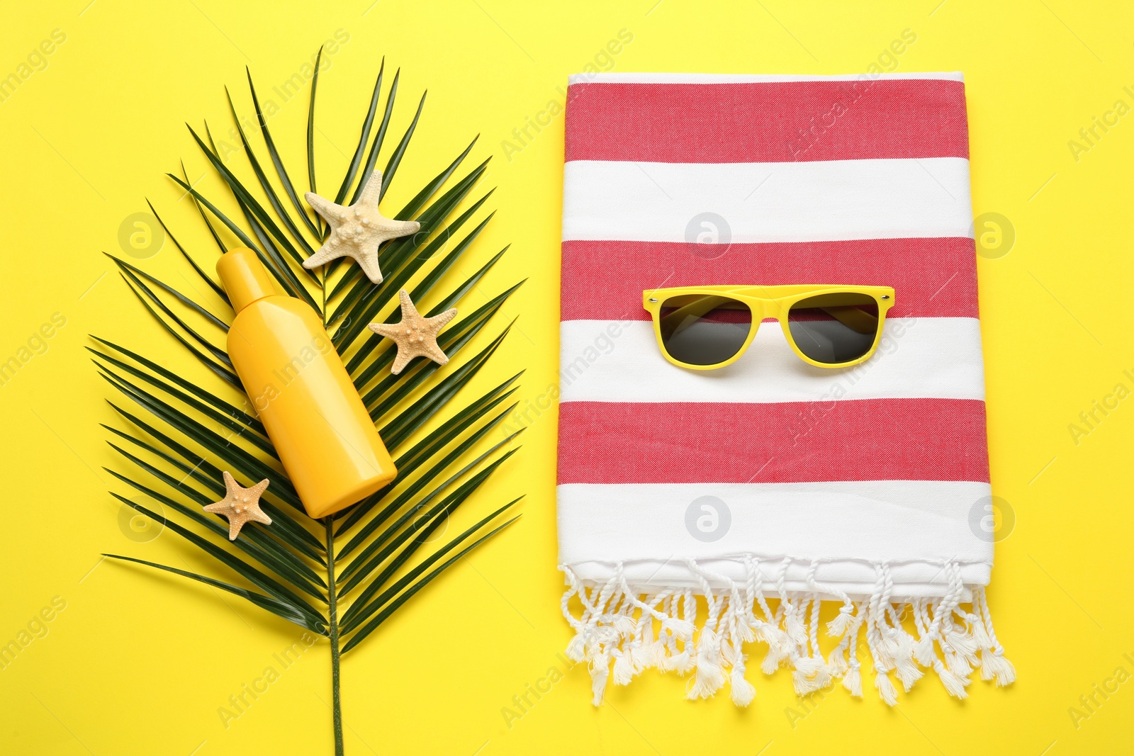 Photo of Flat lay composition with different beach objects on yellow background