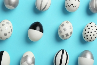Photo of Painted Easter eggs on color background, flat lay