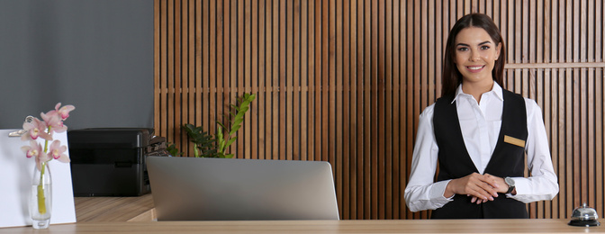 Portrait of receptionist at desk in lobby. Banner design