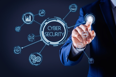 Image of Cyber security concept. Businessman touching virtual screen on dark background, closeup