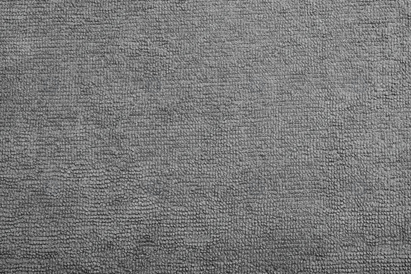 Photo of Grey microfiber cloth as background, top view