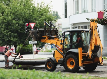 Image of MYKOLAIV, UKRAINE - AUGUST 05, 2021: Workers laying new asphalt on city street. Road repair service