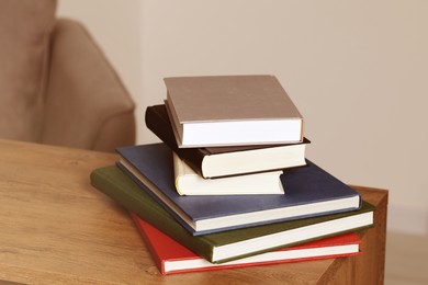 Image of Stack of hardcover books on wooden table indoors