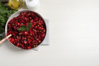 Photo of Delicious fresh vinaigrette salad on white wooden table, flat lay. Space for text