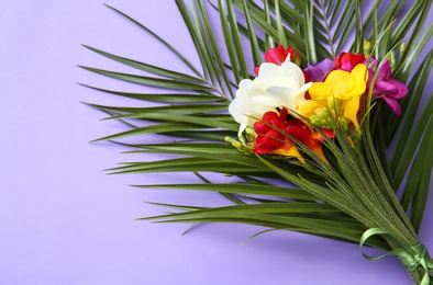 Photo of Beautiful freesia bouquet on color background