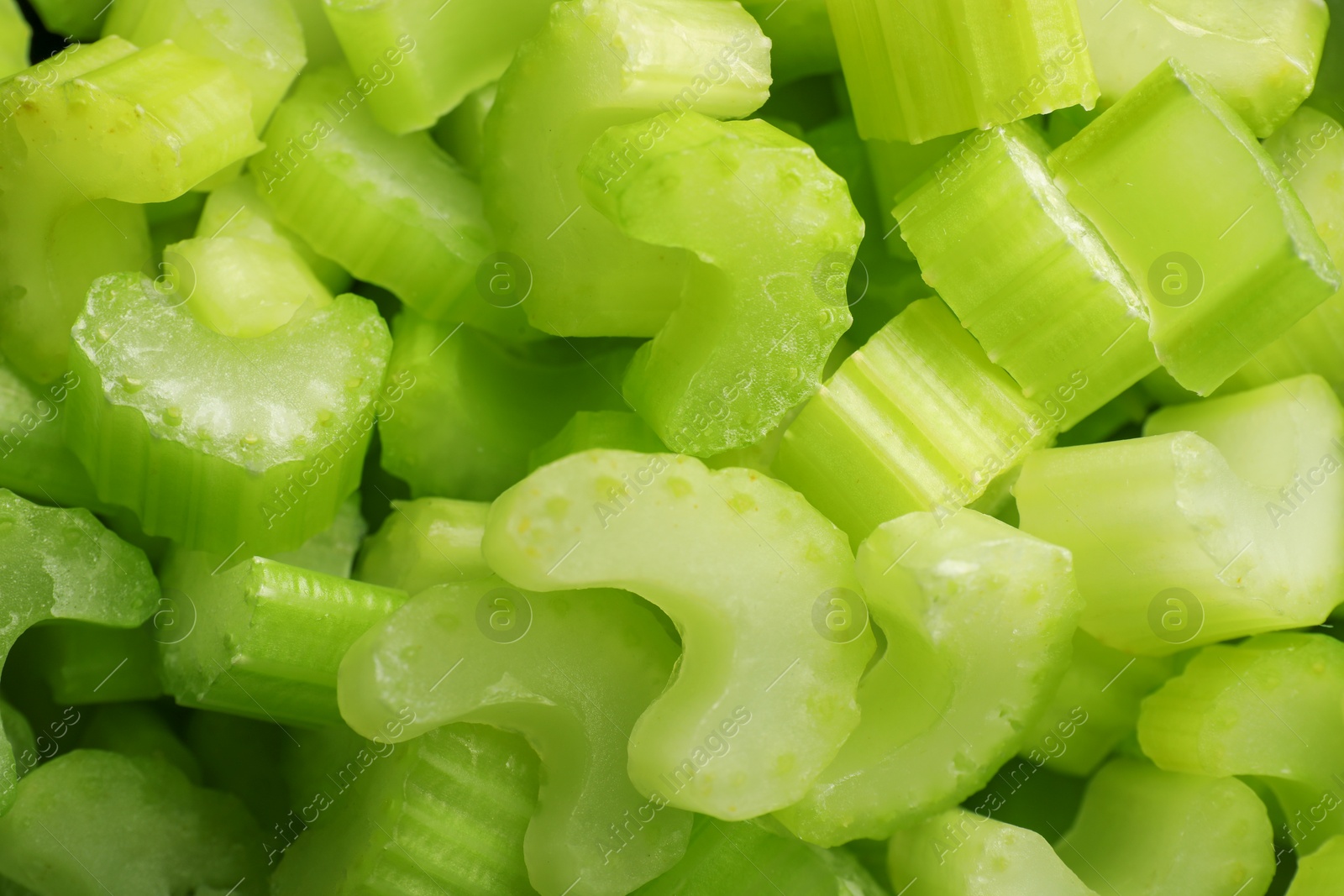 Photo of Many fresh cut celery stalks as background, closeup