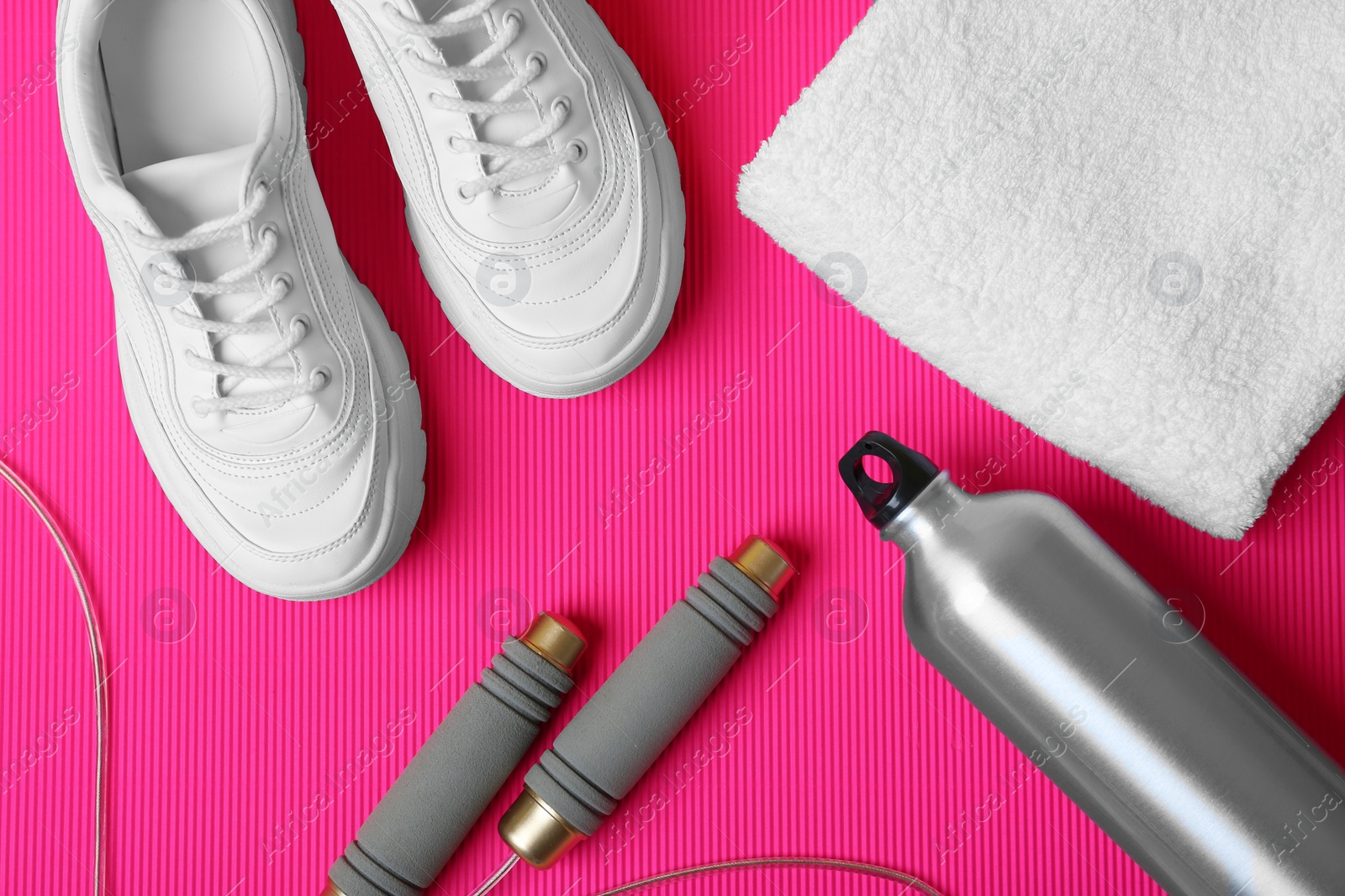 Photo of Flat lay composition with fitness equipment on color background