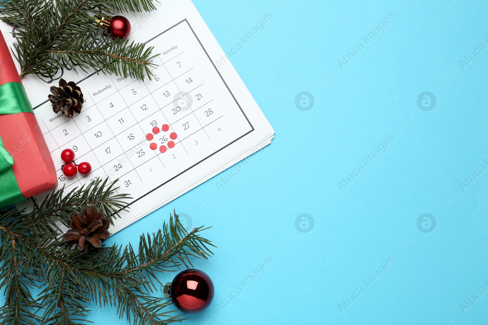 Photo of Flat lay composition with calendar on light blue background, space for text. Boxing day concept