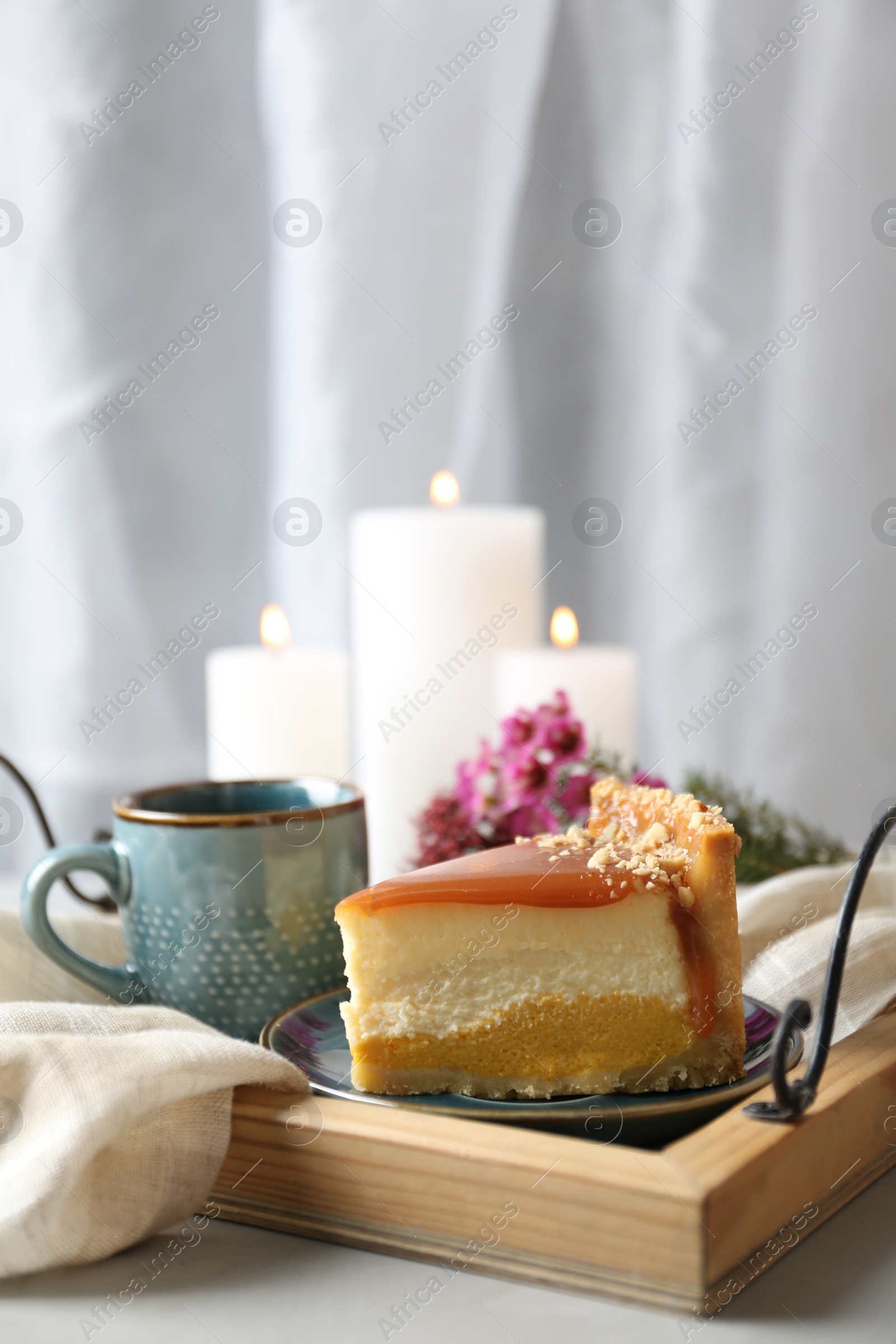 Photo of Cup of tea and delicious cheesecake on grey table