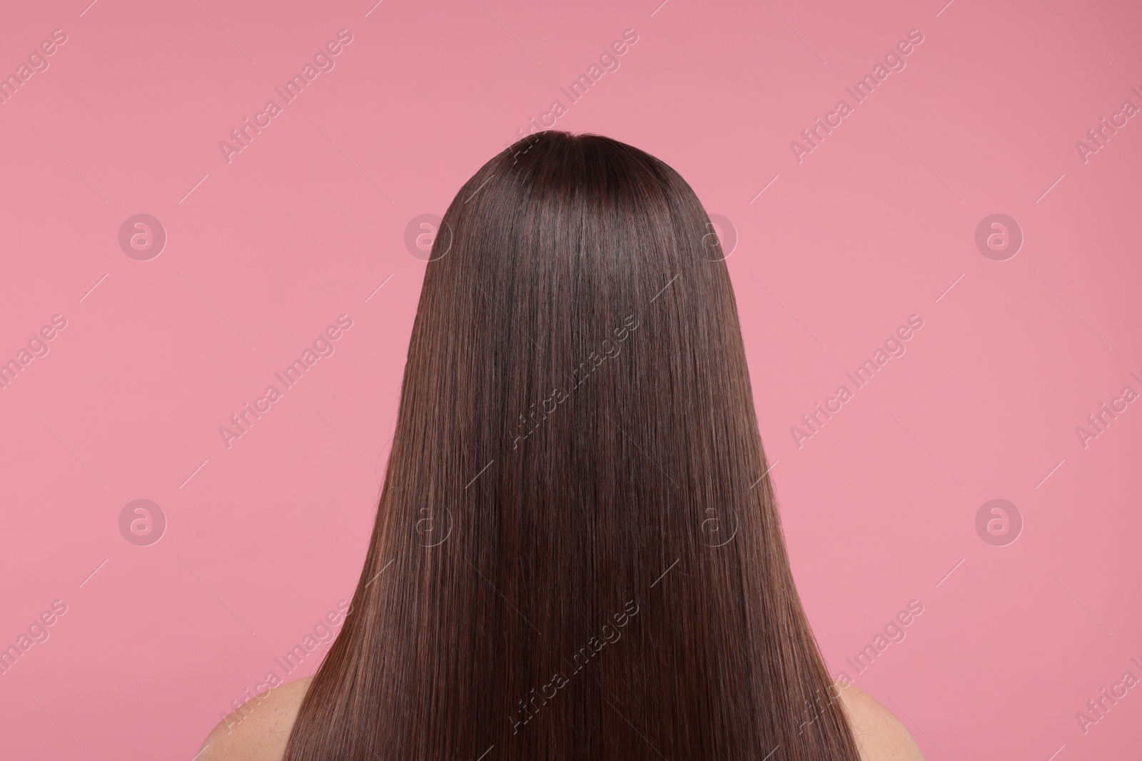 Photo of Woman with smooth healthy hair after treatment on pink background, back view