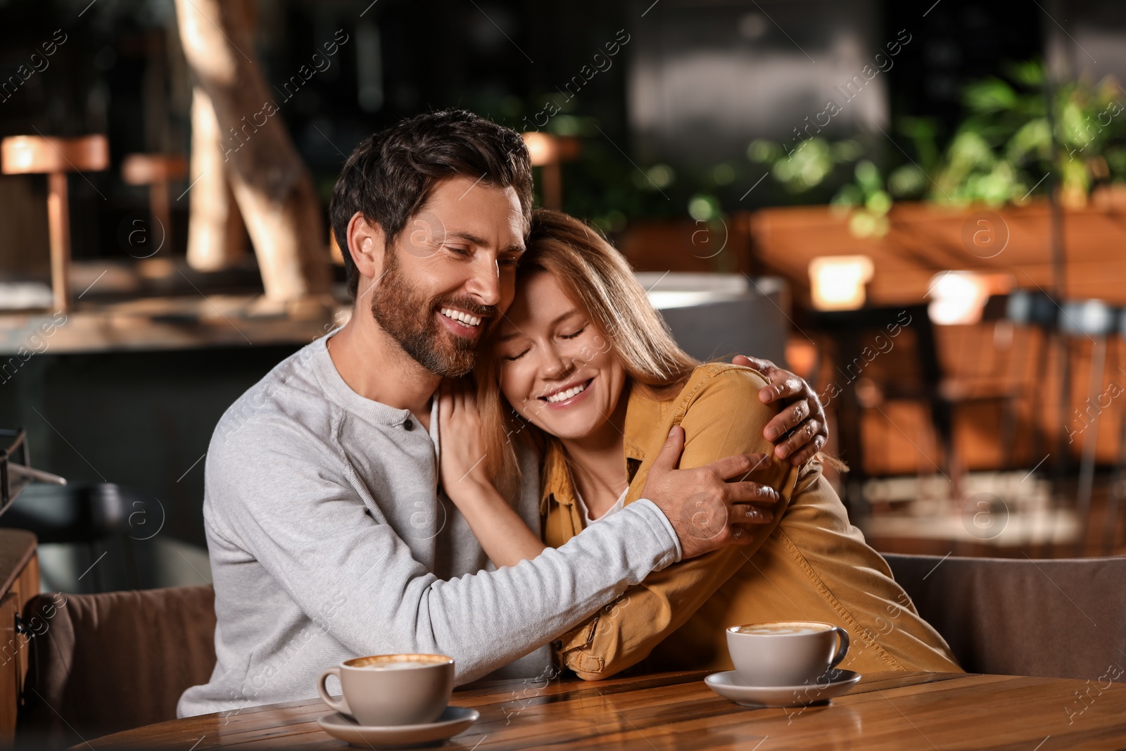 Photo of Romantic date. Happy couple spending time together in cafe