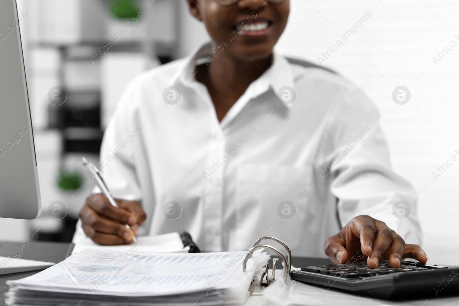 Photo of Professional accountant working at desk in office, closeup