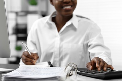 Photo of Professional accountant working at desk in office, closeup