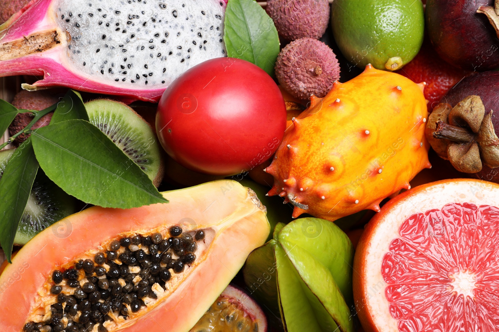 Photo of Different tropical fruits as background, closeup view