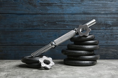 Photo of Composition with dumbbell plates and sport equipment on floor