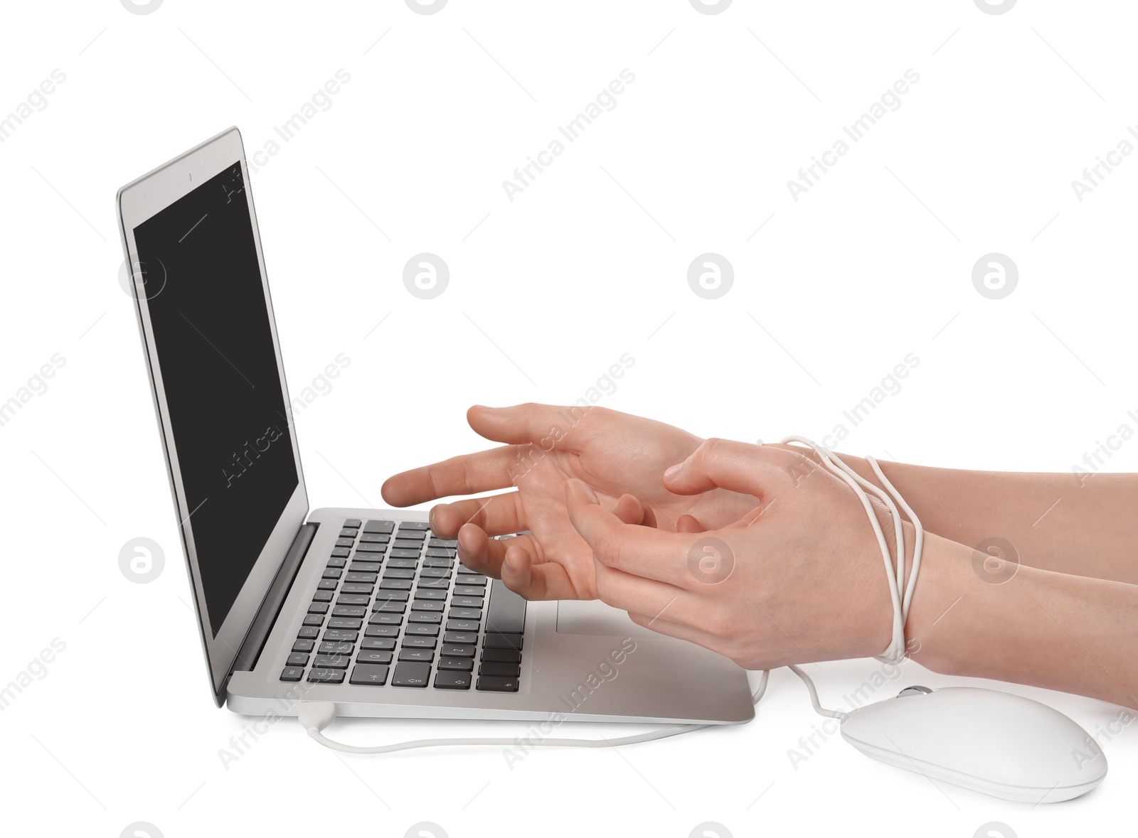 Photo of Woman showing hands tied to laptop with computer mouse cable on white background, closeup. Internet addiction