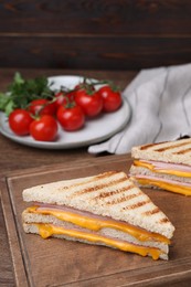 Photo of Delicious grilled sandwiches with ham and cheese on table, space for text