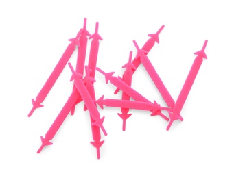 Pink silicone shoe laces on white background, top view