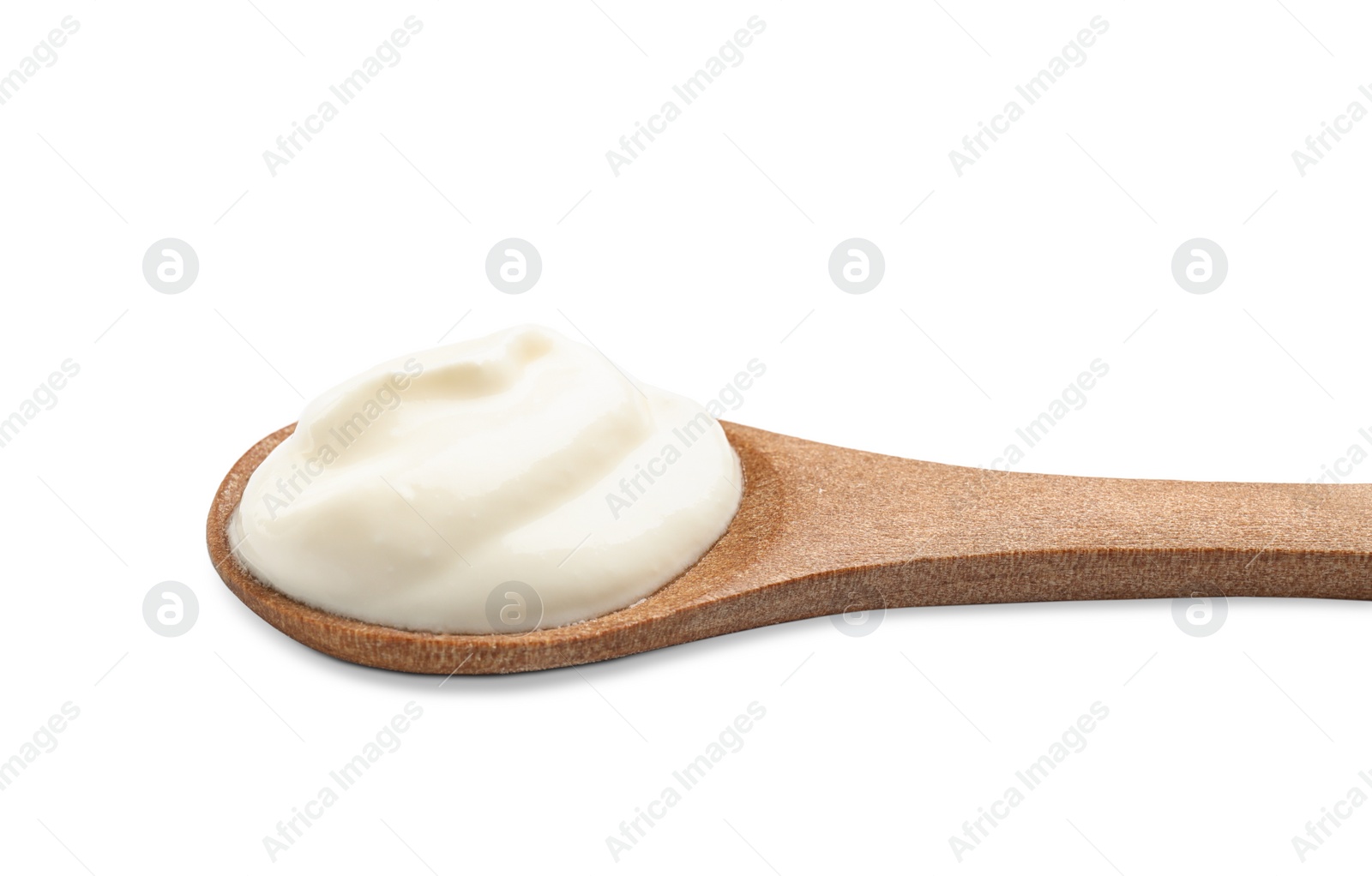 Photo of Wooden spoon with sour cream on white background