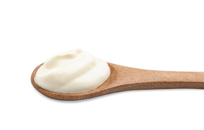 Wooden spoon with sour cream on white background