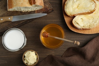 Photo of Flat lay composition of honey, milk and butter on wooden table