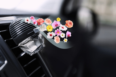 Image of Air freshener clip attached to car ventilation. Flowered aroma