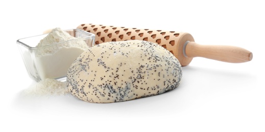 Photo of Raw dough with poppy seeds, flour in bowl and rolling pin on white background