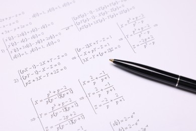 Photo of Sheet of paper with mathematical formulas and pen