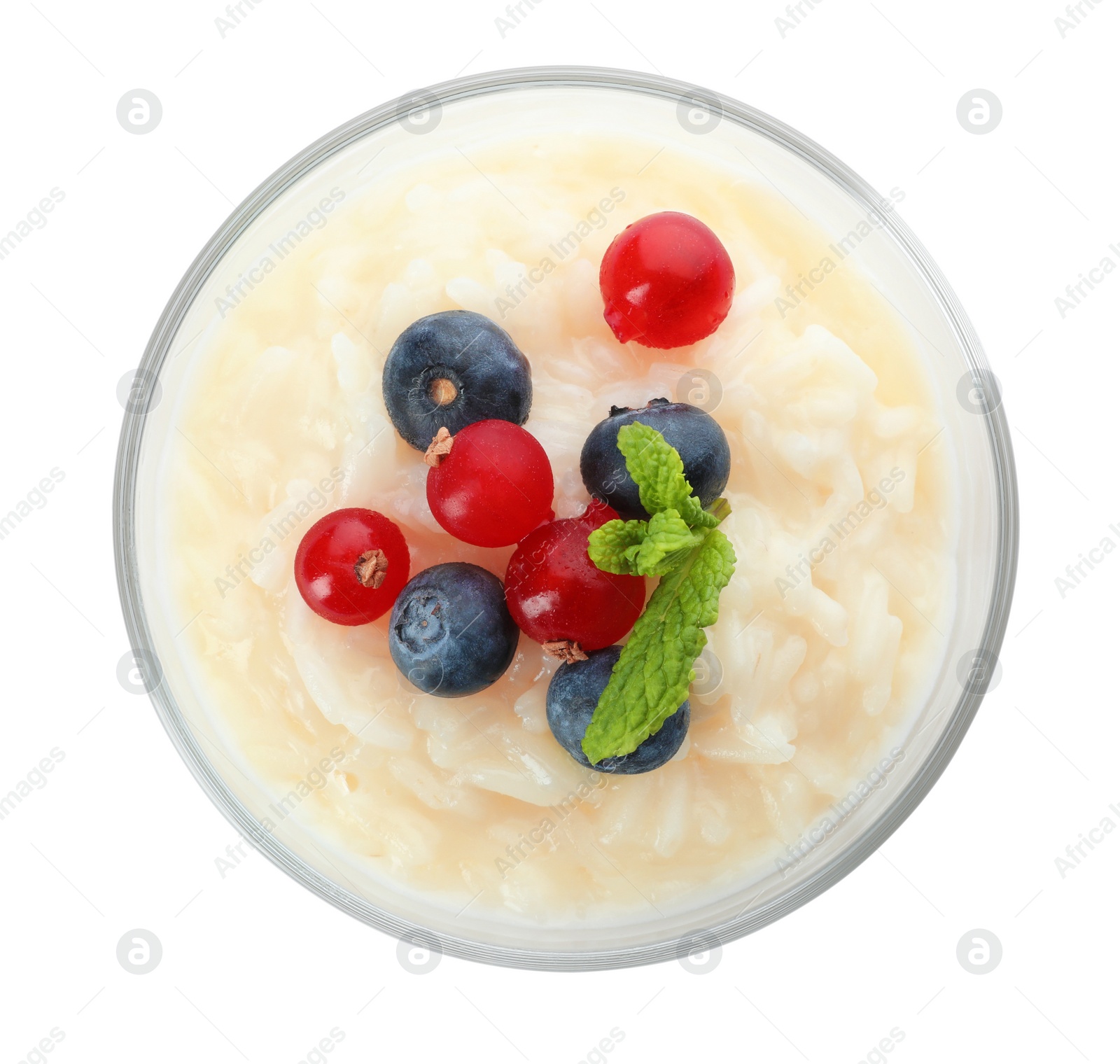 Photo of Delicious rice pudding with berries isolated on white, top view