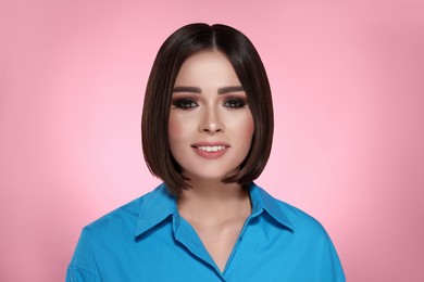 Image of Portrait of stylish pretty young woman with brown hair on pink background