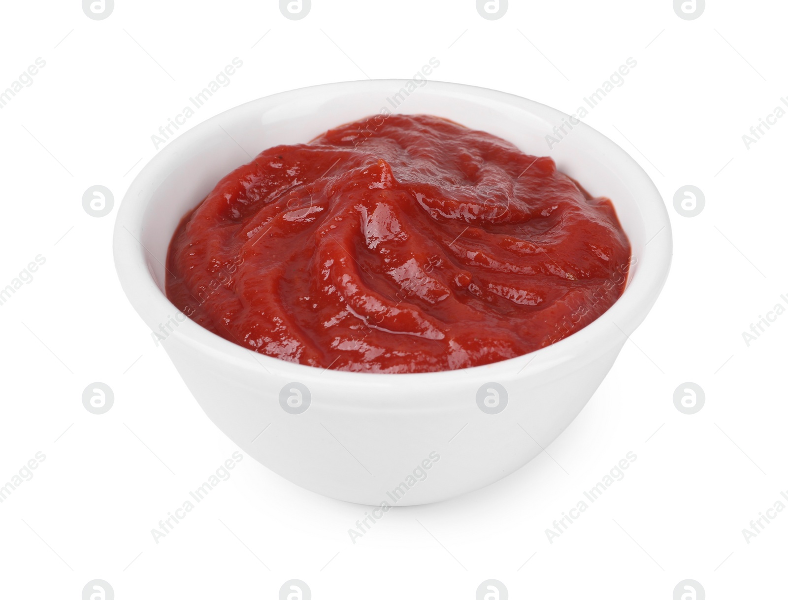 Photo of Organic ketchup in bowl isolated on white. Tomato sauce