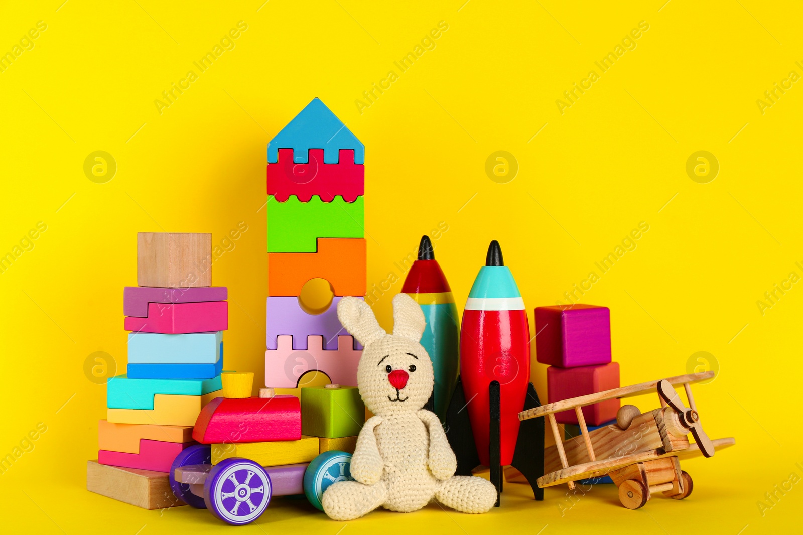 Photo of Set of different toys on yellow background