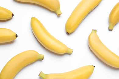 Photo of Sweet ripe baby bananas on white background, top view