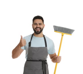 Young man with yellow broom on white background