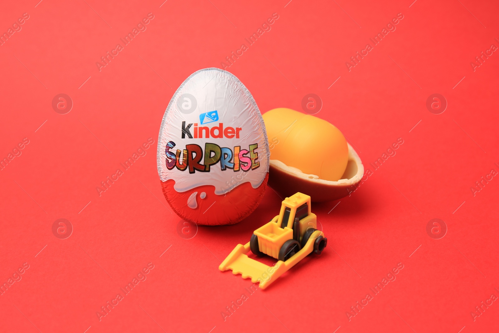 Photo of Sveti Vlas, Bulgaria - June 29, 2023: Kinder Surprise Eggs, plastic capsule and toy on red background