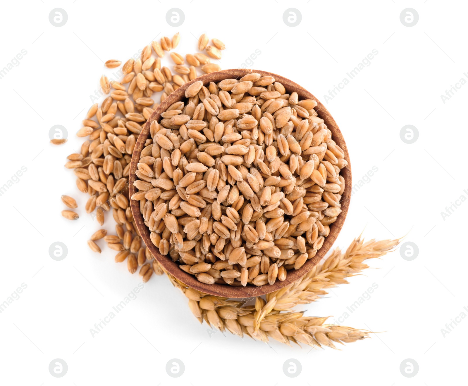 Photo of Wooden bowl with wheat grains and spikes on white background, top view