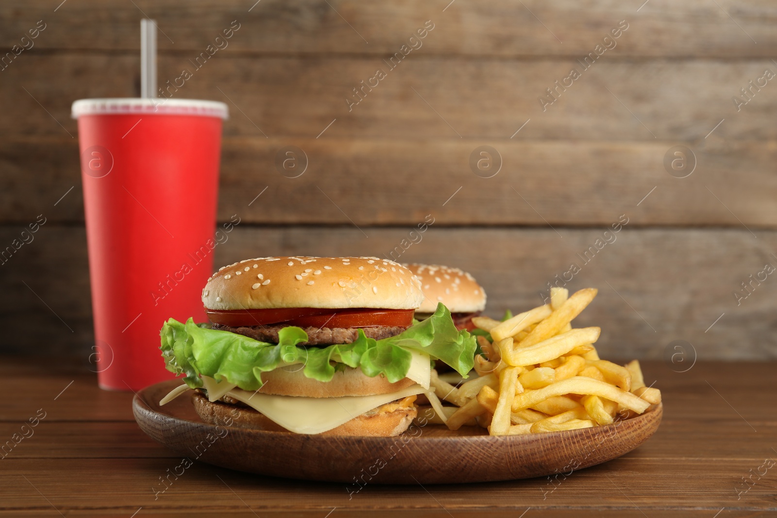 Photo of Delicious fast food menu on wooden table