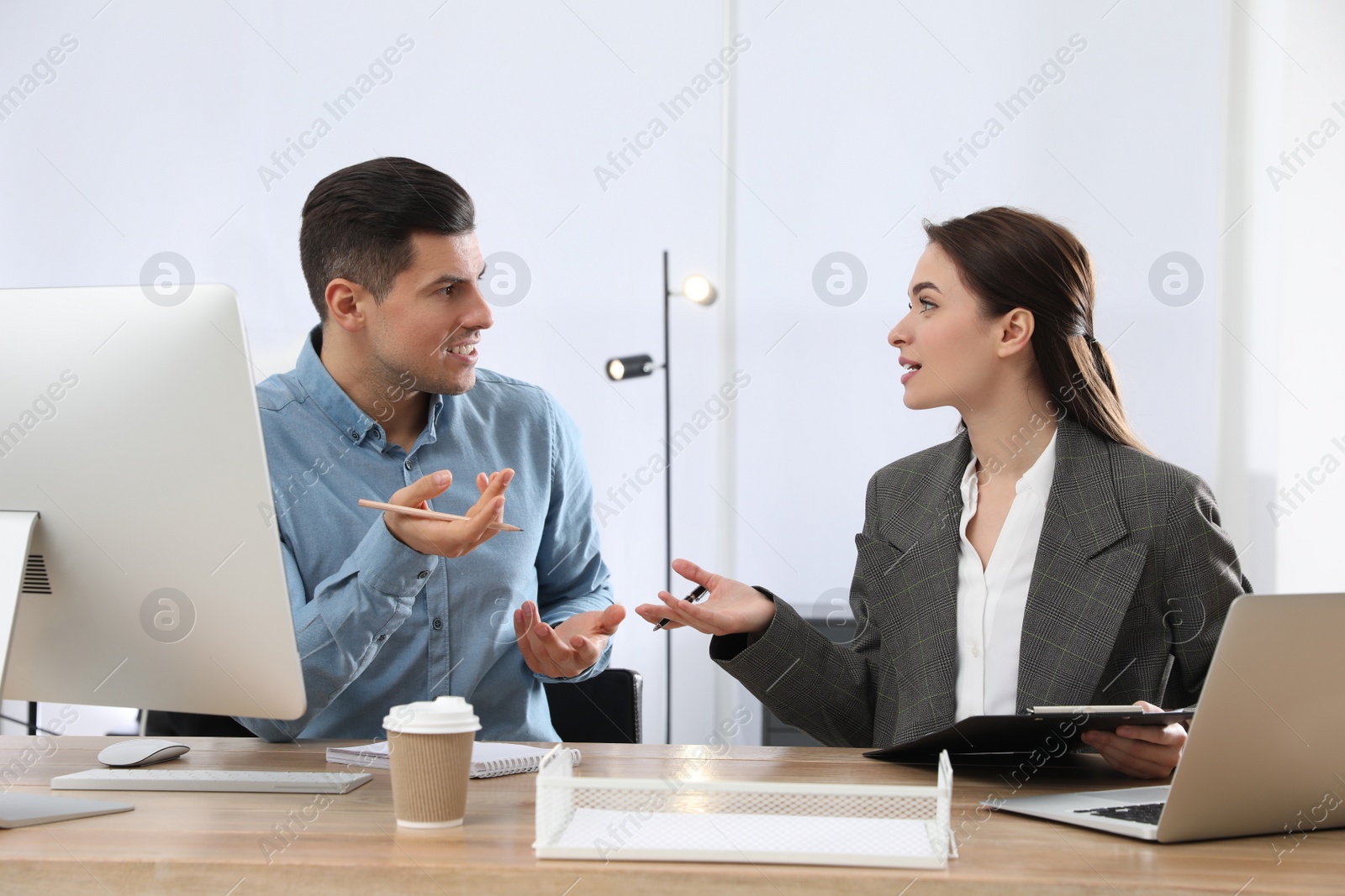 Photo of Businesswoman helping intern with work in office