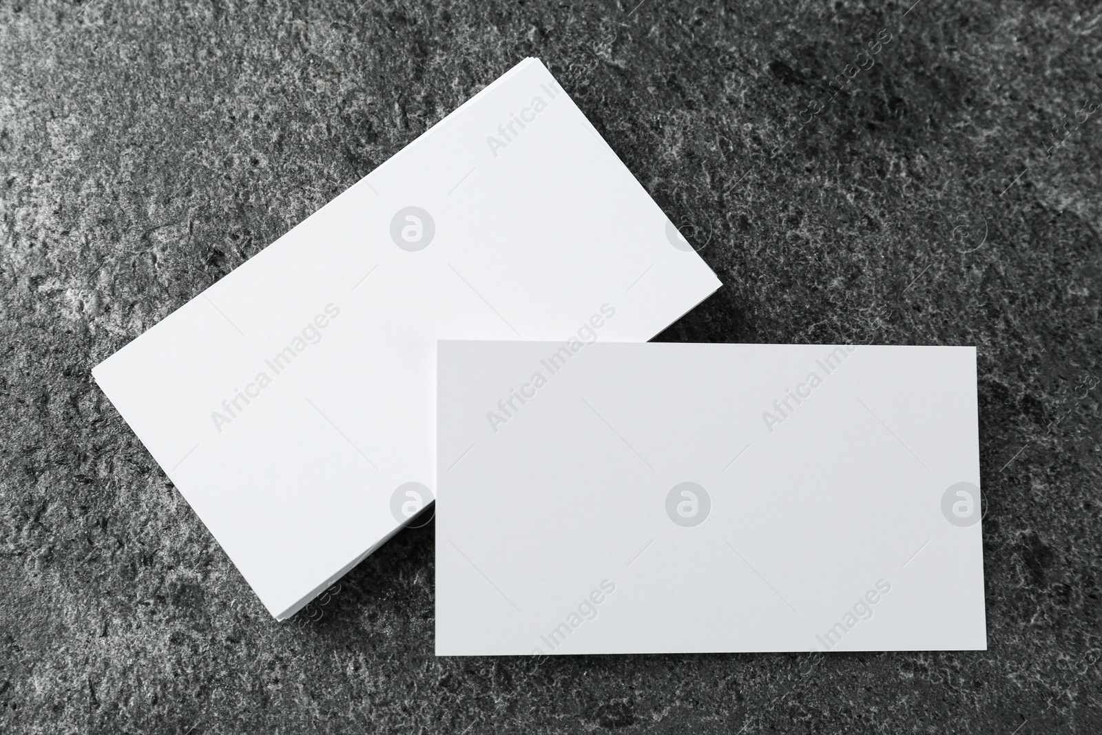 Photo of Blank business cards on grey table, flat lay. Mockup for design