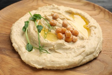 Photo of Bowl of tasty hummus with chickpeas, closeup