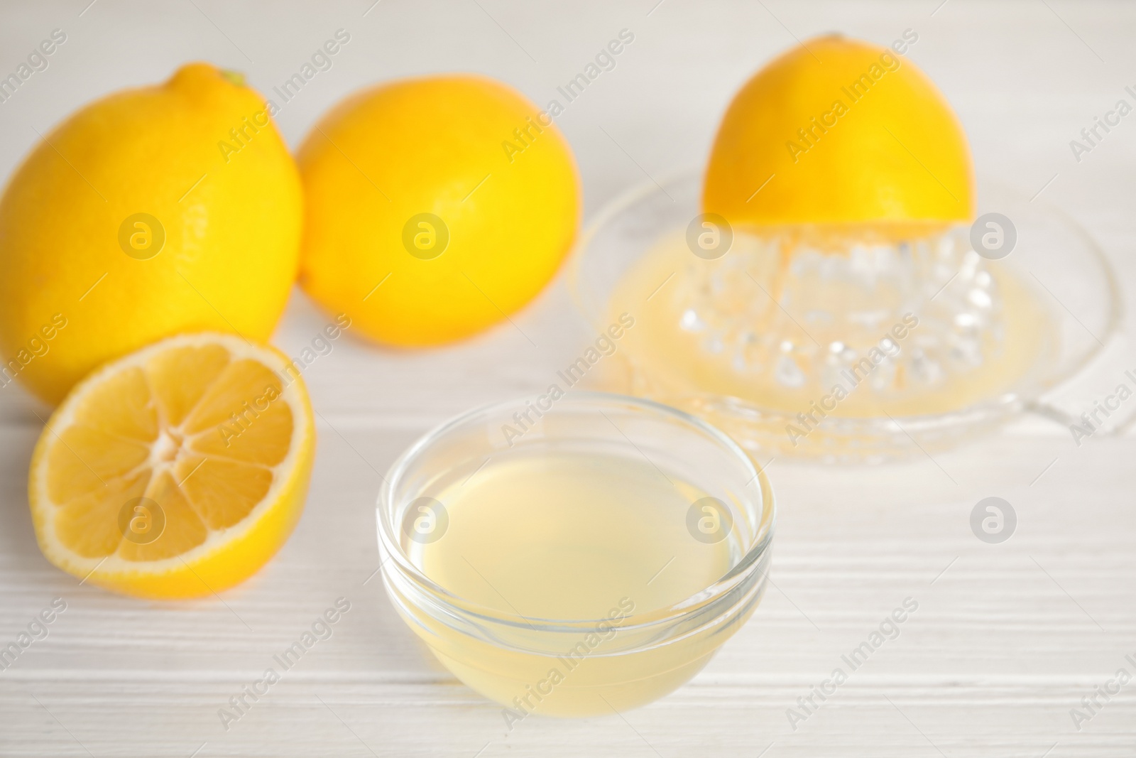 Photo of Freshly squeezed lemon juice on white table